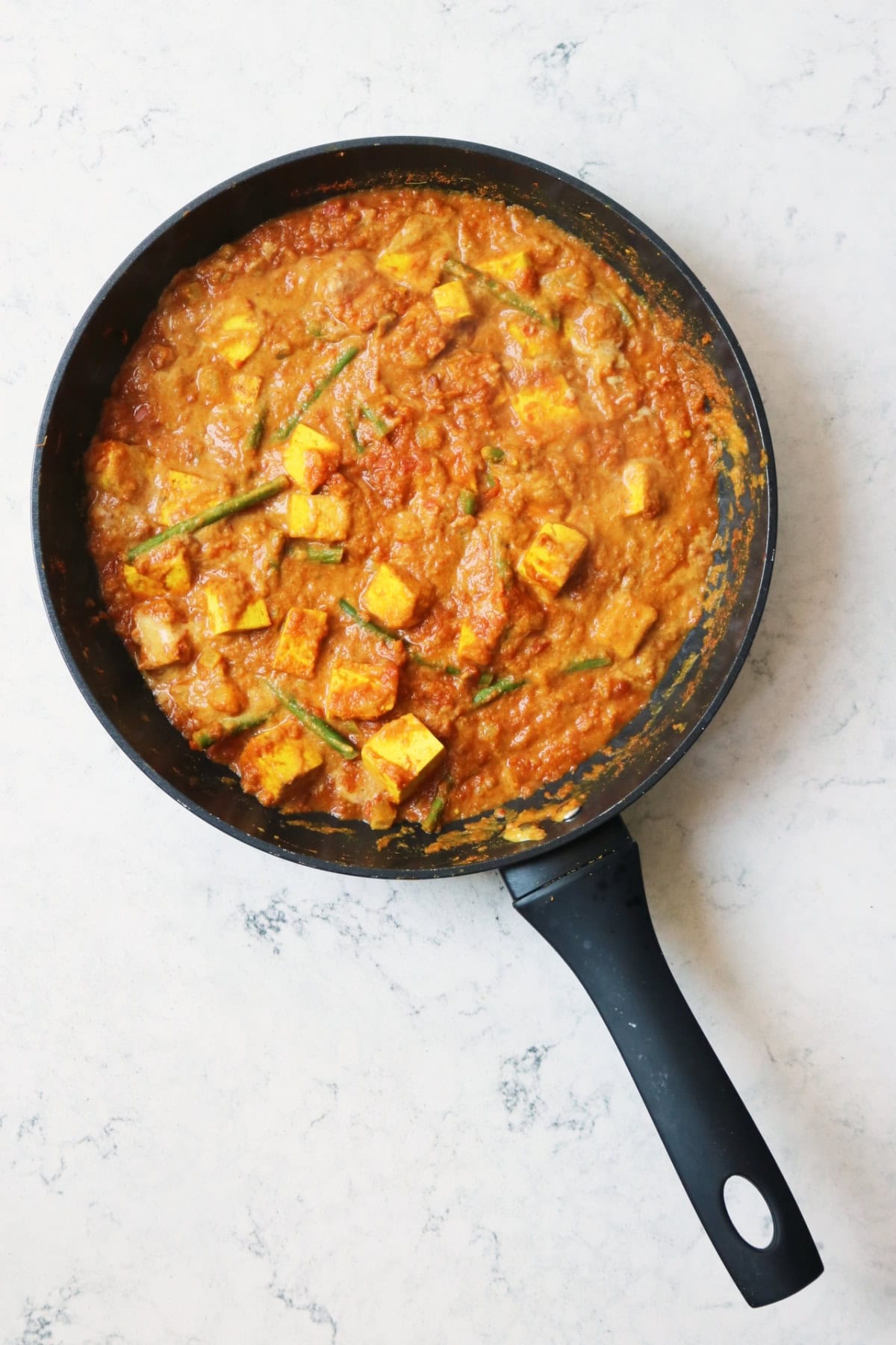 Vegan Green Bean and Tofu Curry simmering in a large frying pan