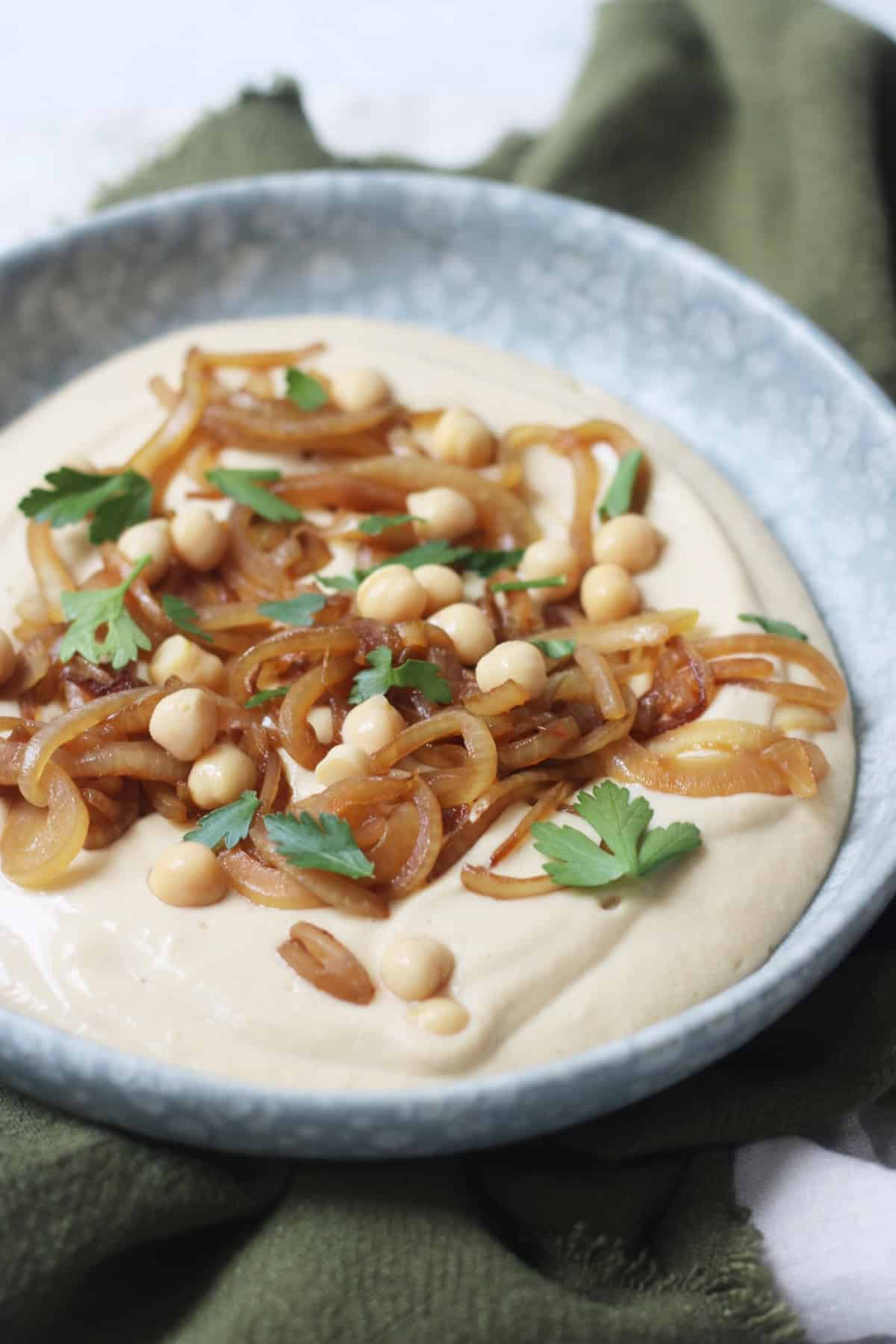 Vegan Caramelised Onion and Miso Dip on a plate topped with parsley