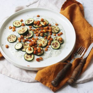 Baby courgettes crispy chickpeas and vegan tzatziki on a plate