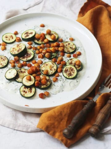 Baby courgettes crispy chickpeas and vegan tzatziki on a plate