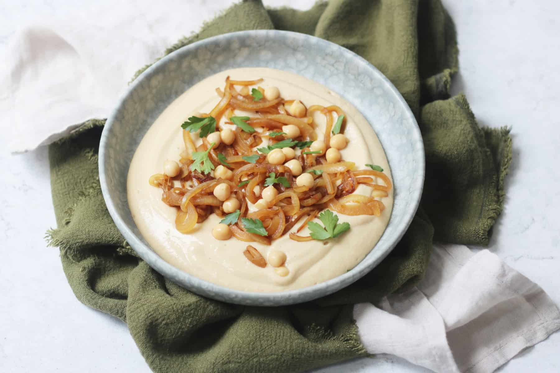 Vegan Caramelised Onion and Miso Dip on a plate topped with parsley
