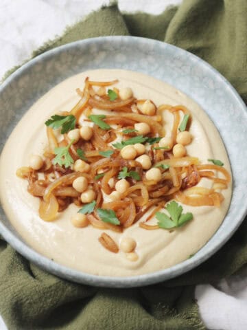 Vegan Caramelised Onion and Miso Dip on a plate topped with parsley