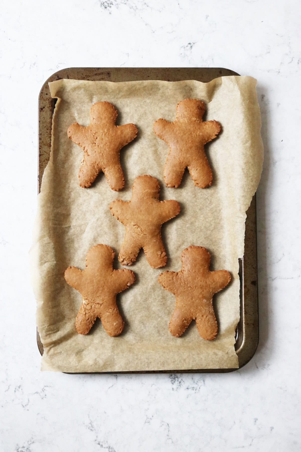 Halloween gingerbread on a baking tray fresh out of the oven
