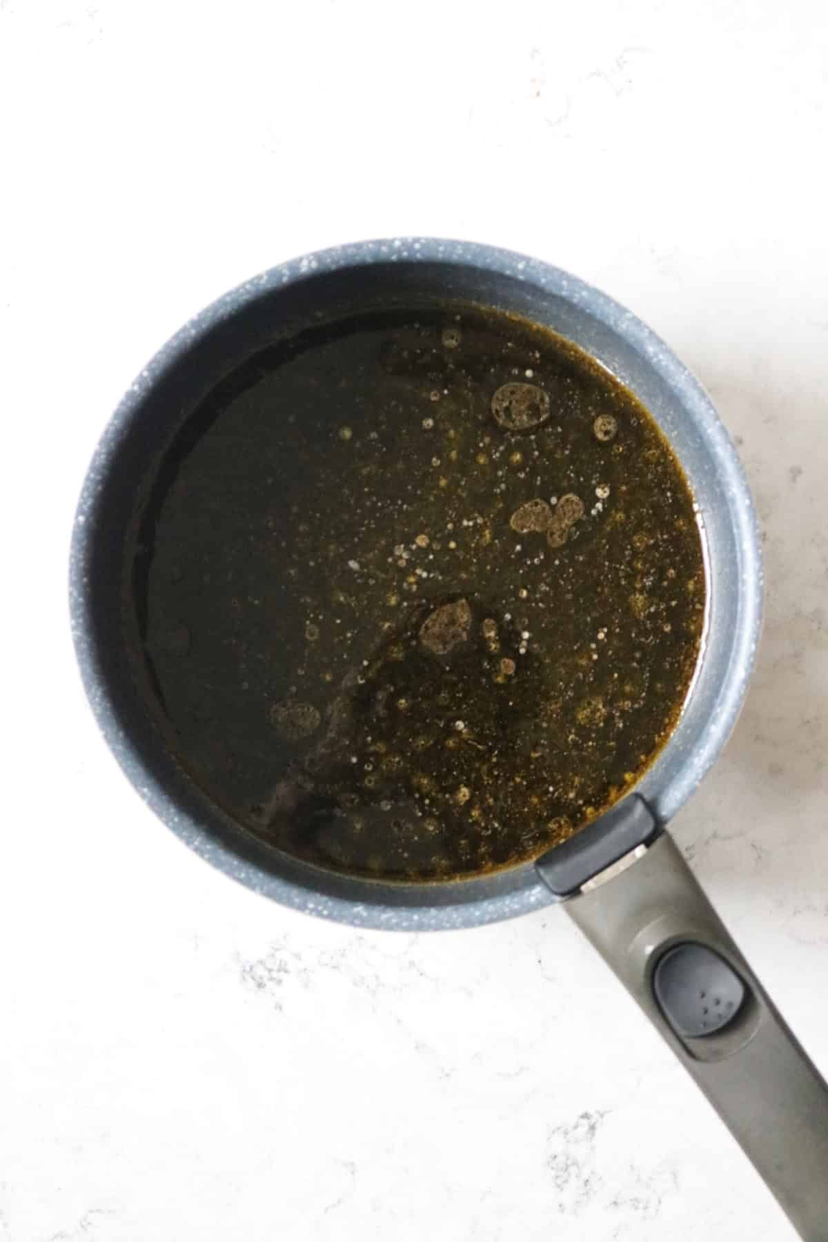 Melted sugar, butter, treacle and golden syrup in a saucepan