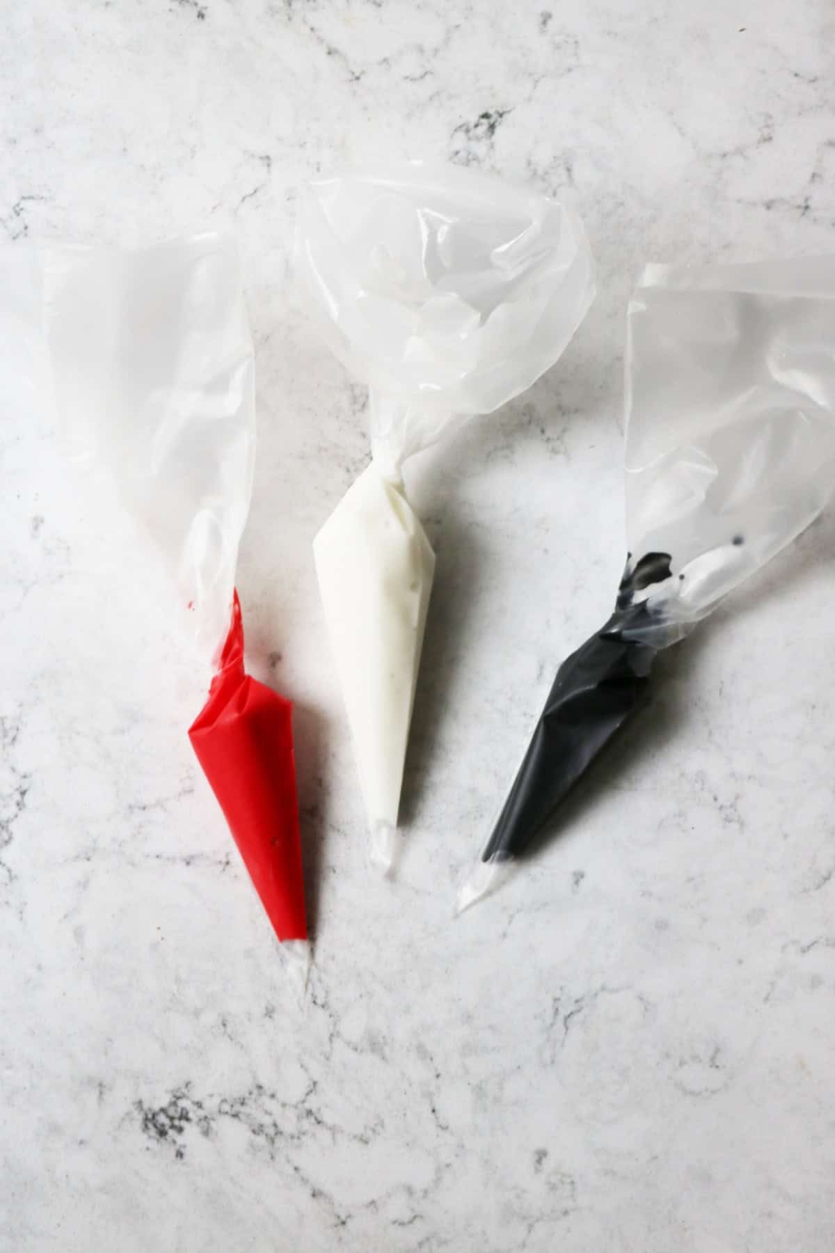 Icing bags filled with red, white and black icing