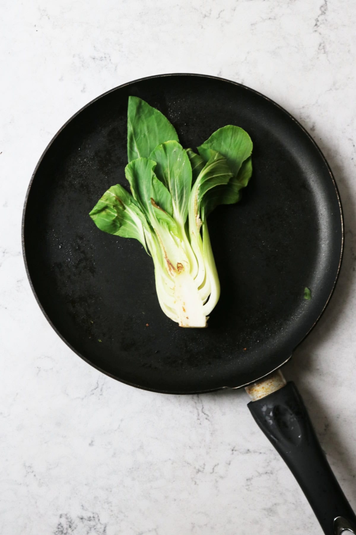 Pak choi stir frying in a pan