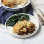 A portion of Rösti-Topped Puy Lentil and Mushroom Pie served with cavolo nero
