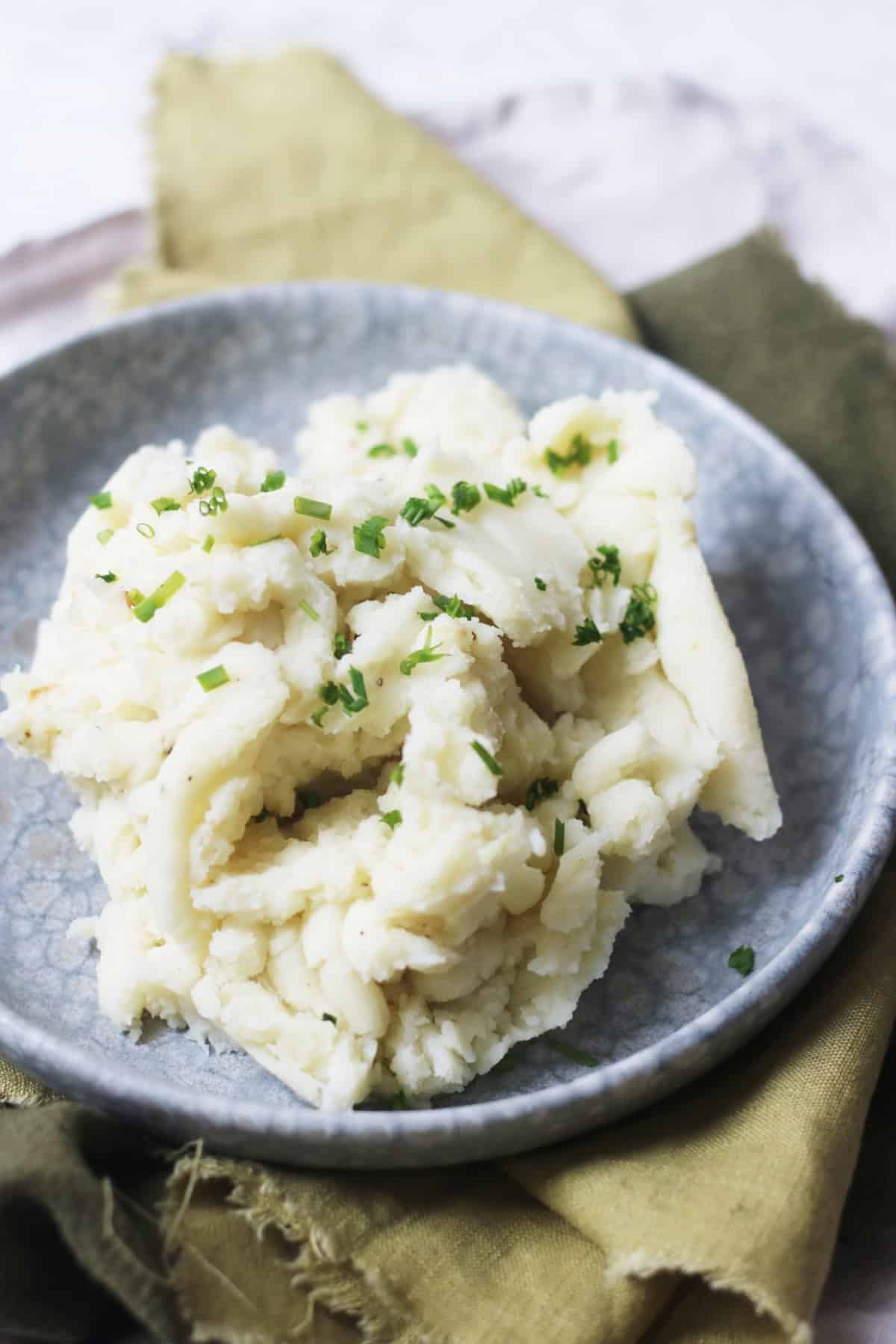 Vegan Garlicky Mashed Potatoes with Chives served on a plate