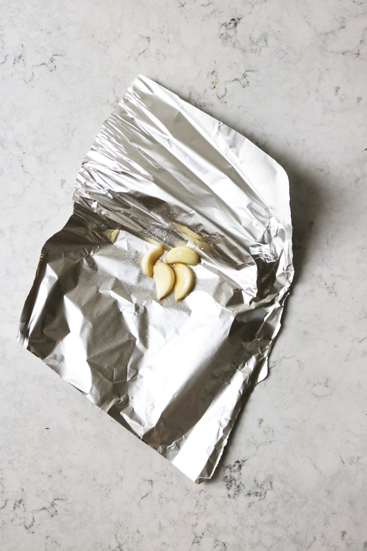 Garlic on tinfoil drizzled with olive oil