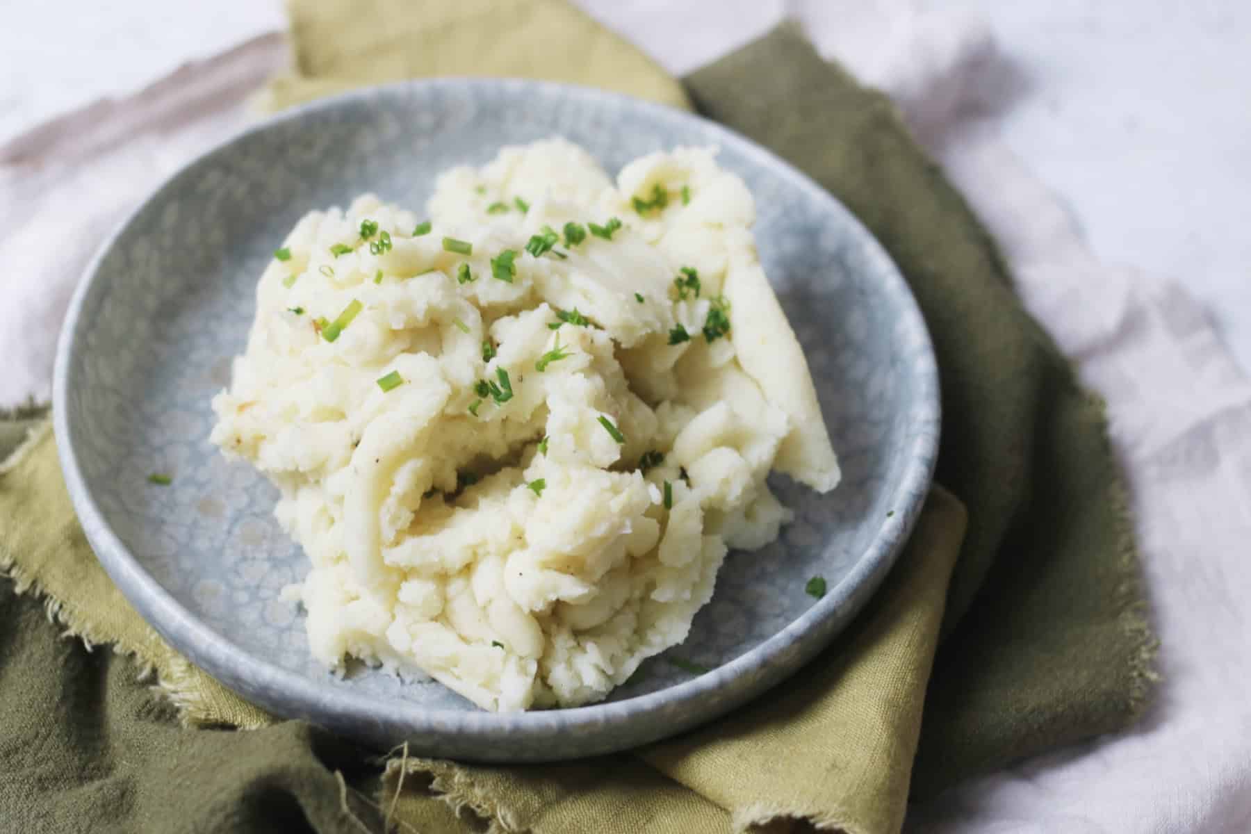 Vegan Garlicky Mashed Potatoes with Chives served on a plate