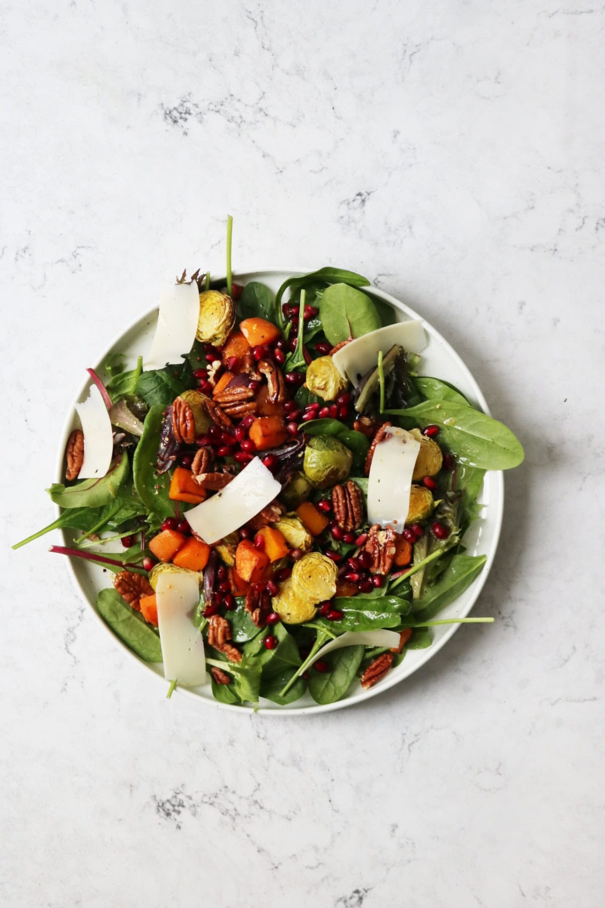 Festive Salad on a plate sat on a white marble counter top