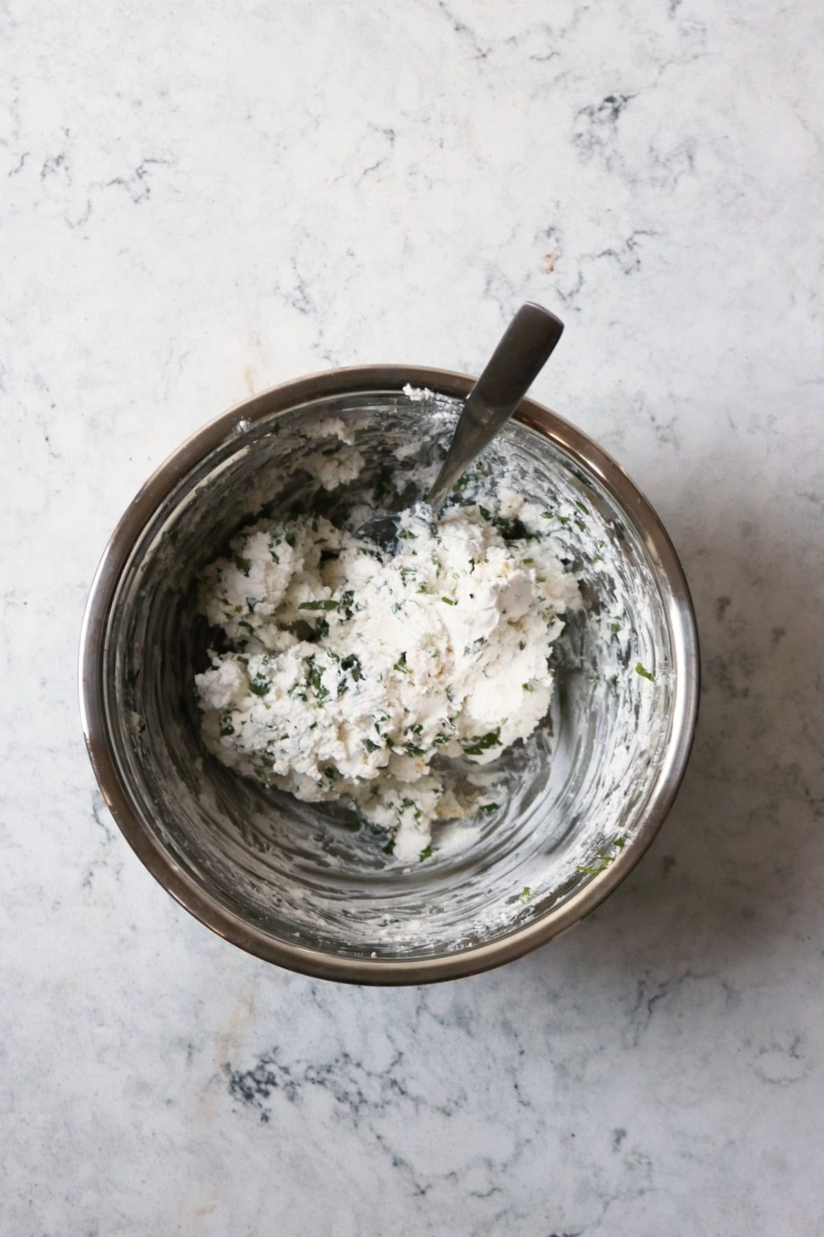 The vegan cream cheese filling for Vegan Sun-dried Tomato and Feta Pinwheels in a metal mixing bowl