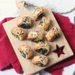 Vegan Spinach and Artichoke Rolls arrange on a wooden serving board
