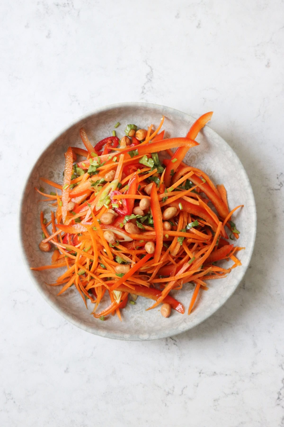 Carrot Salad dressed with soy and ginger, topped with peanuts, chilli, coriander and spring onions