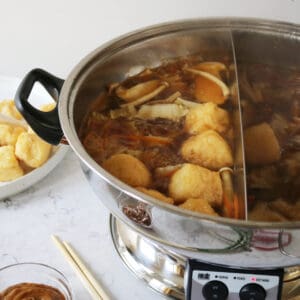 A hot pot machine with Vegan Mongolian Hot Pot cooking inside