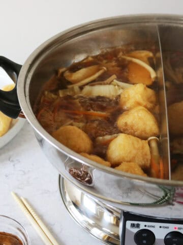 A hot pot machine with Vegan Mongolian Hot Pot cooking inside