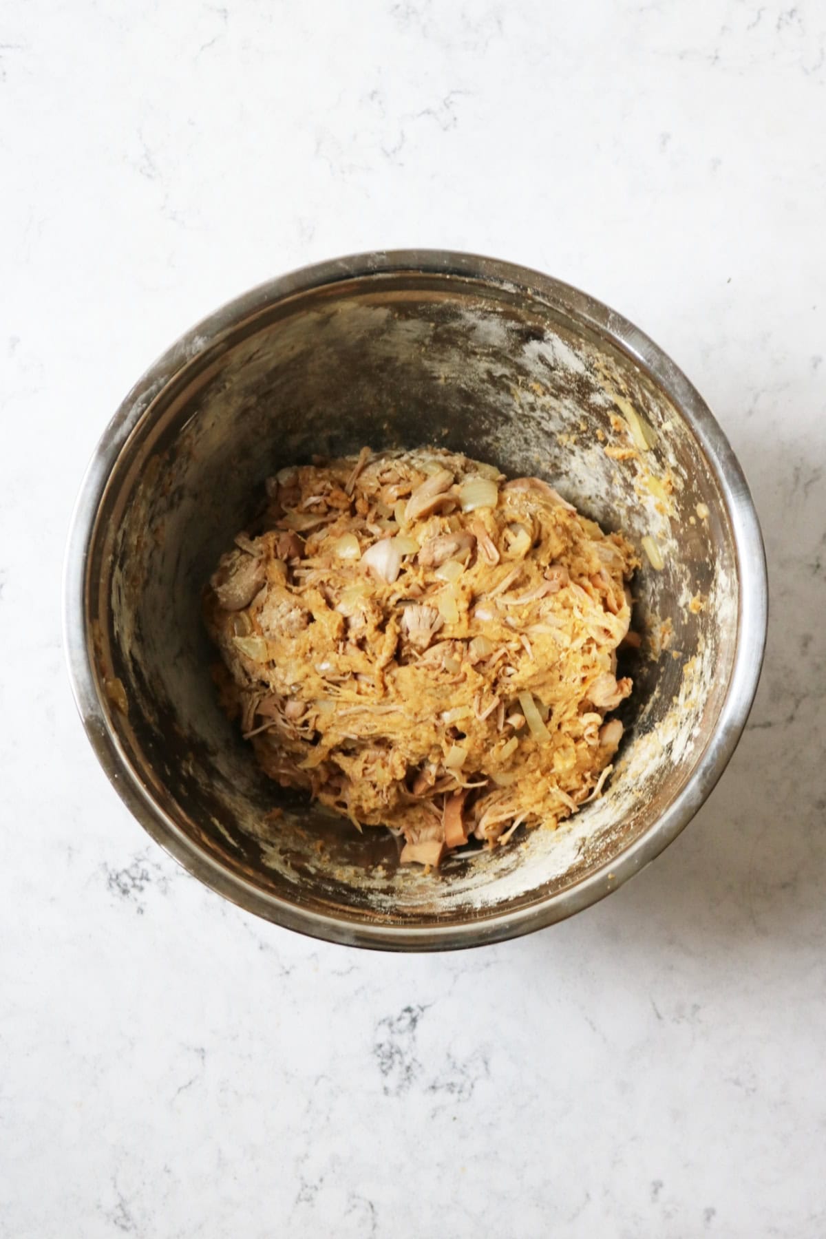A ball of jackfruit and vital wheat gluten dough in a metal mixing bowl