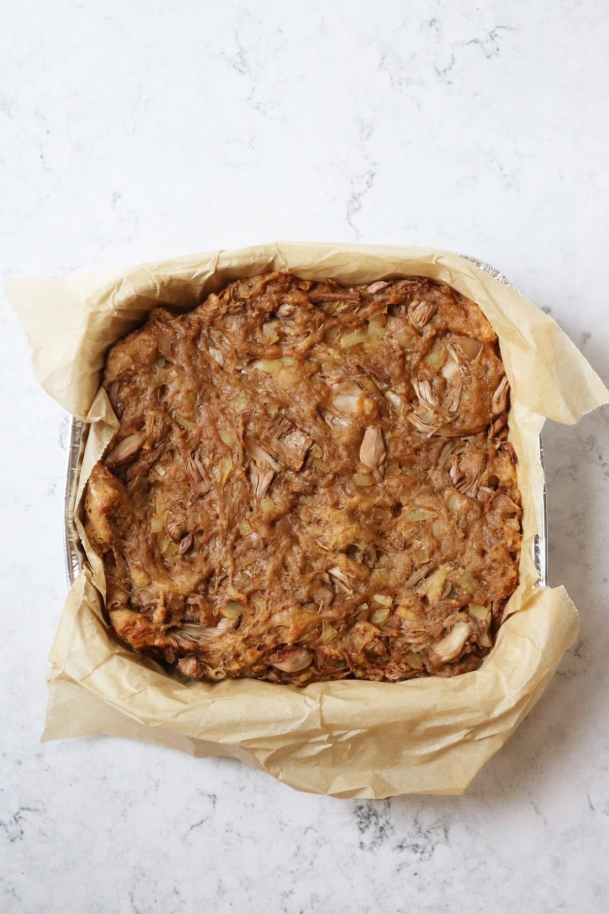 A mixture of vital wheat gluten and jackfruit cooked in a pan to form the basis of Chinese ribs