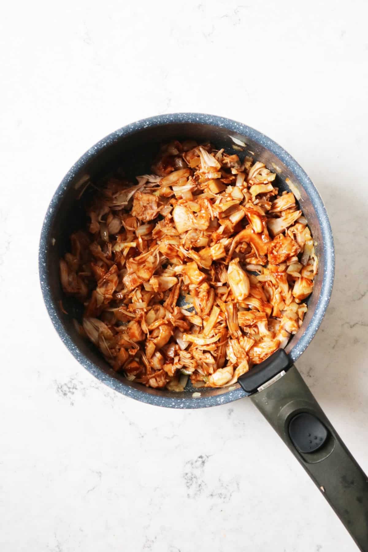 Jackfruit and onions cooking in BBQ sauce