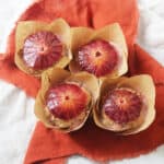 Vegan Blood Orange & Cardamom Breakfast Muffins topped with a slice of blood orange