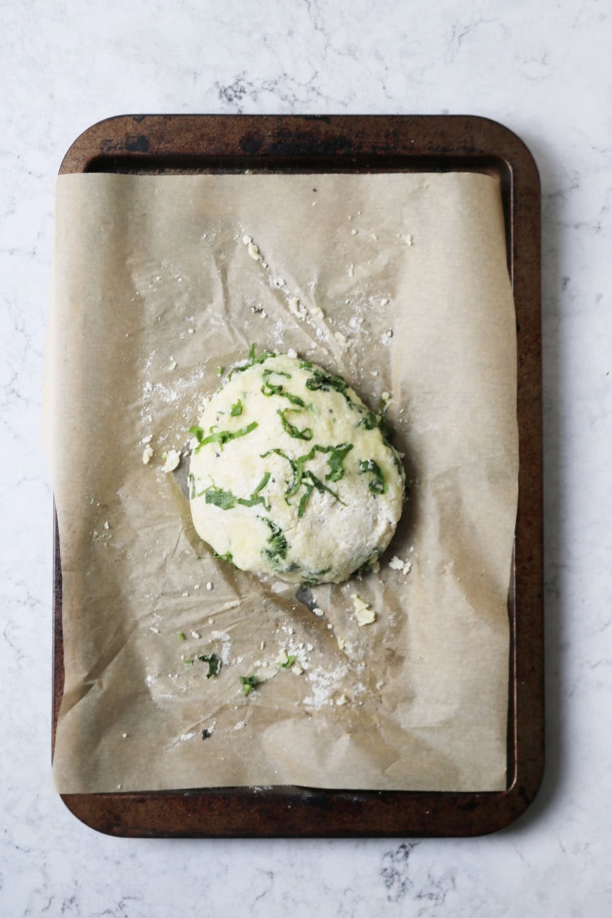 A ball of gnocchi dough made from flour, mashed potato and wild garlic