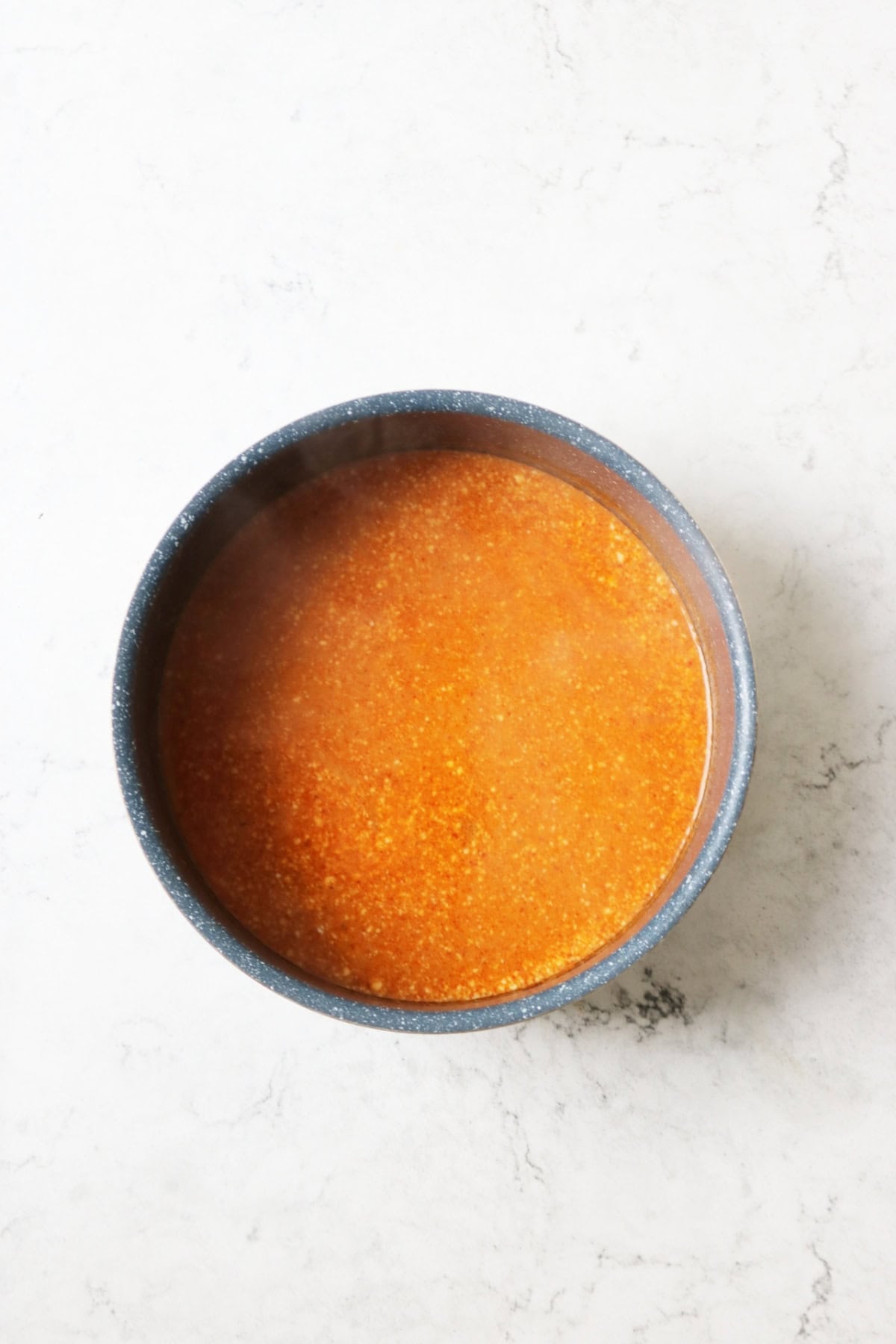 The broth for Vegan Thai Red Curry Noodle Soup simmering in a saucepan