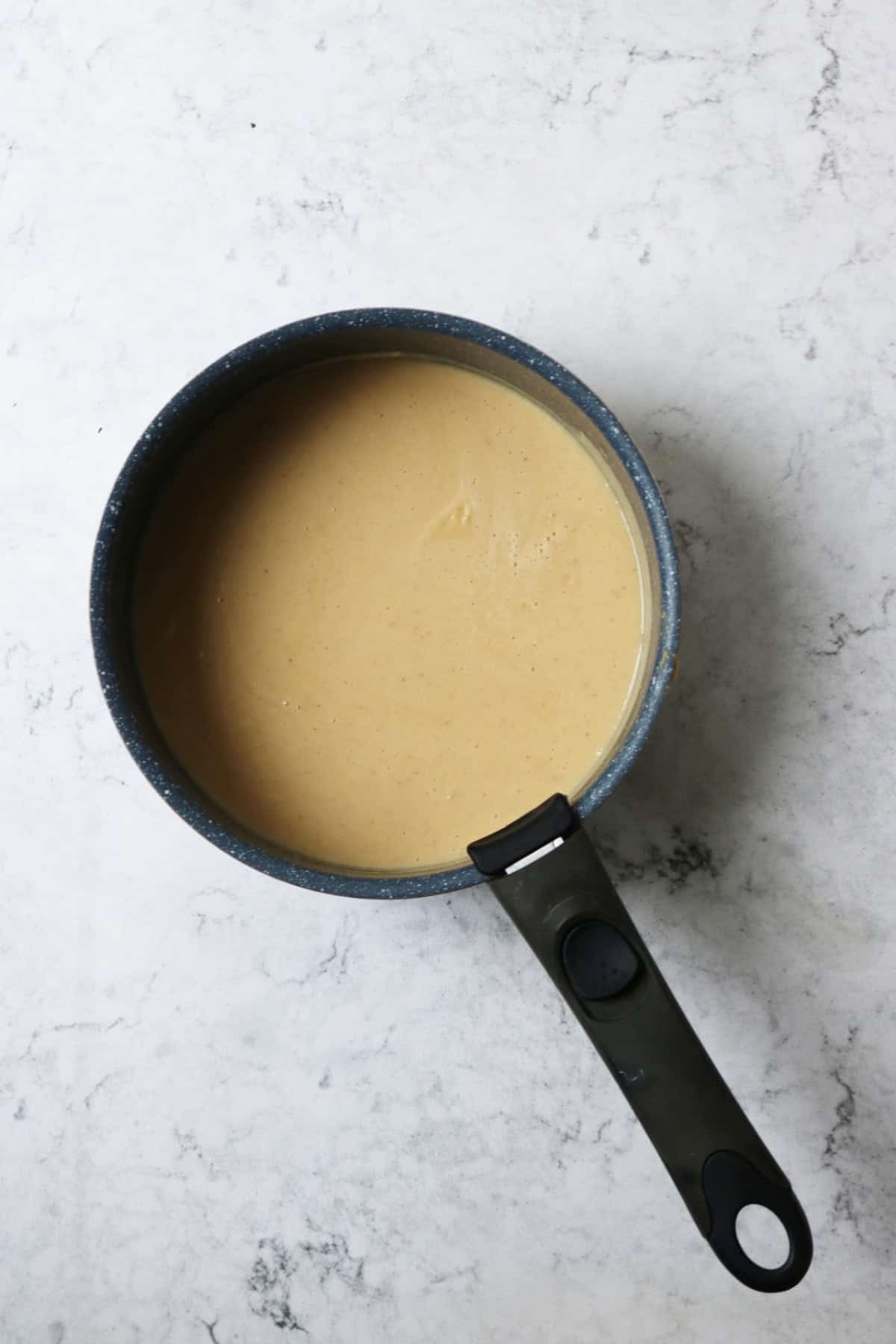 A saucepan of creamy cauliflower broth simmering
