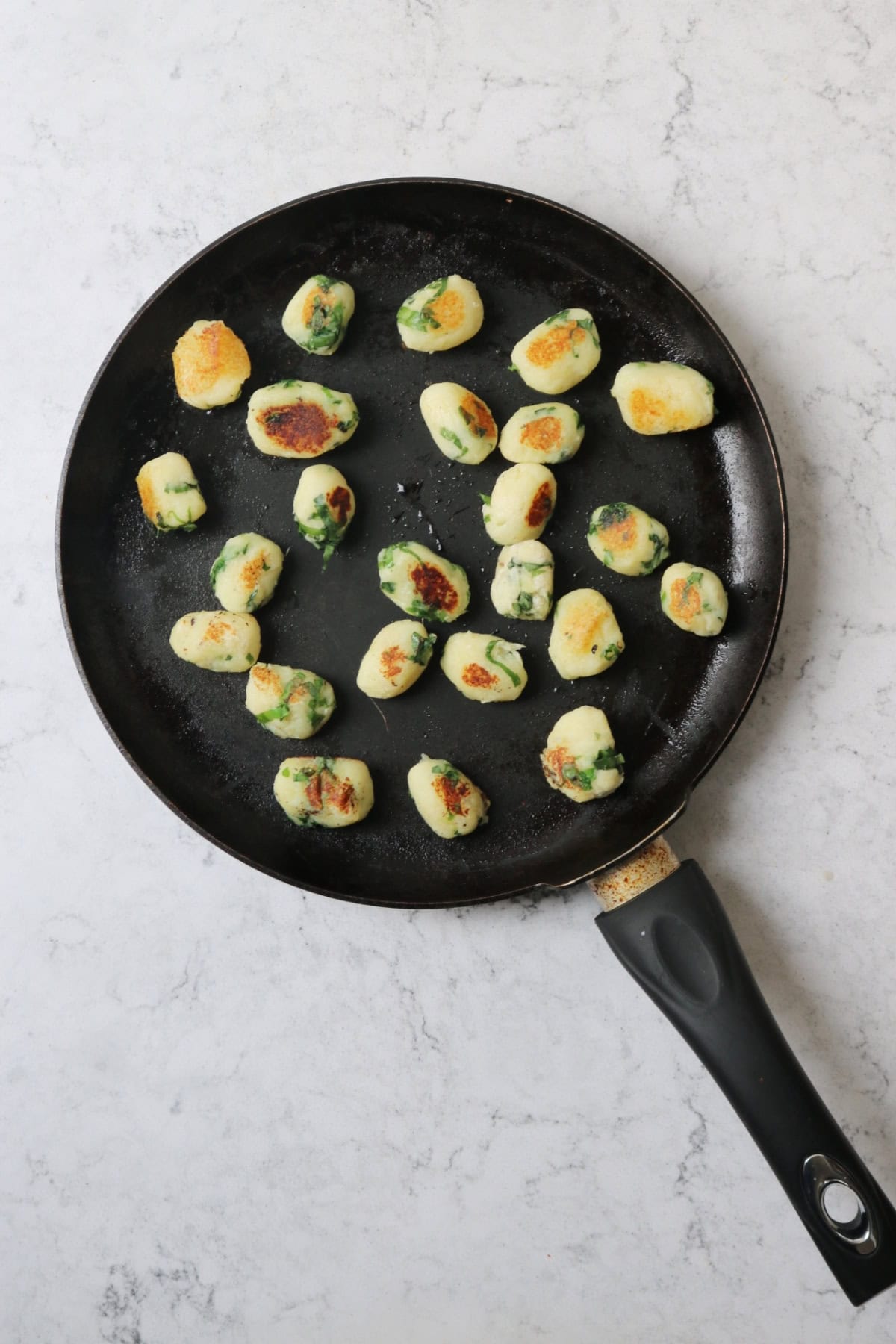 Pan fried cooked vegan wild garlic gnocchi