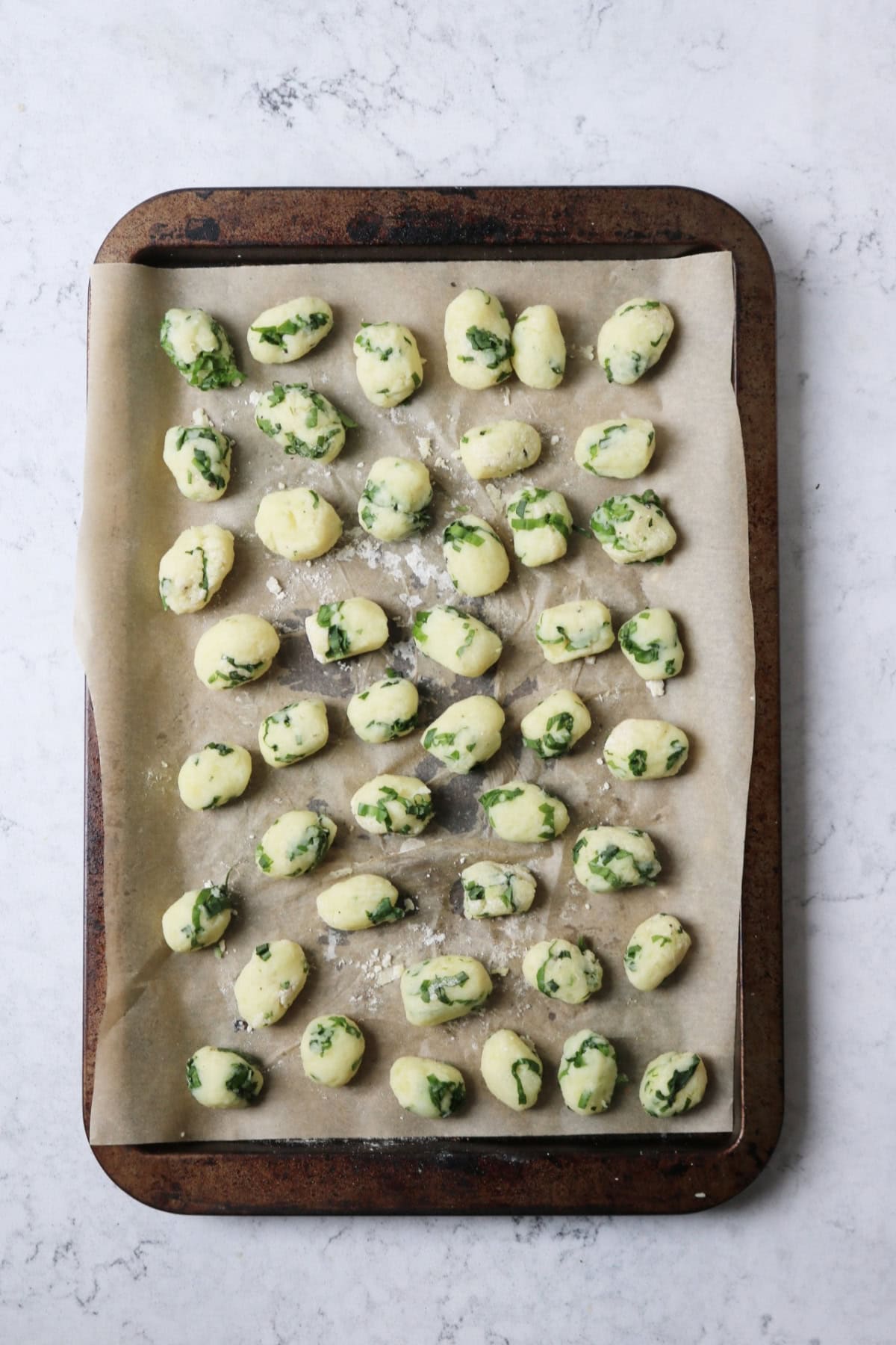 A tray of vegan wild garlic gnocchi that have been rolled out before being cooked