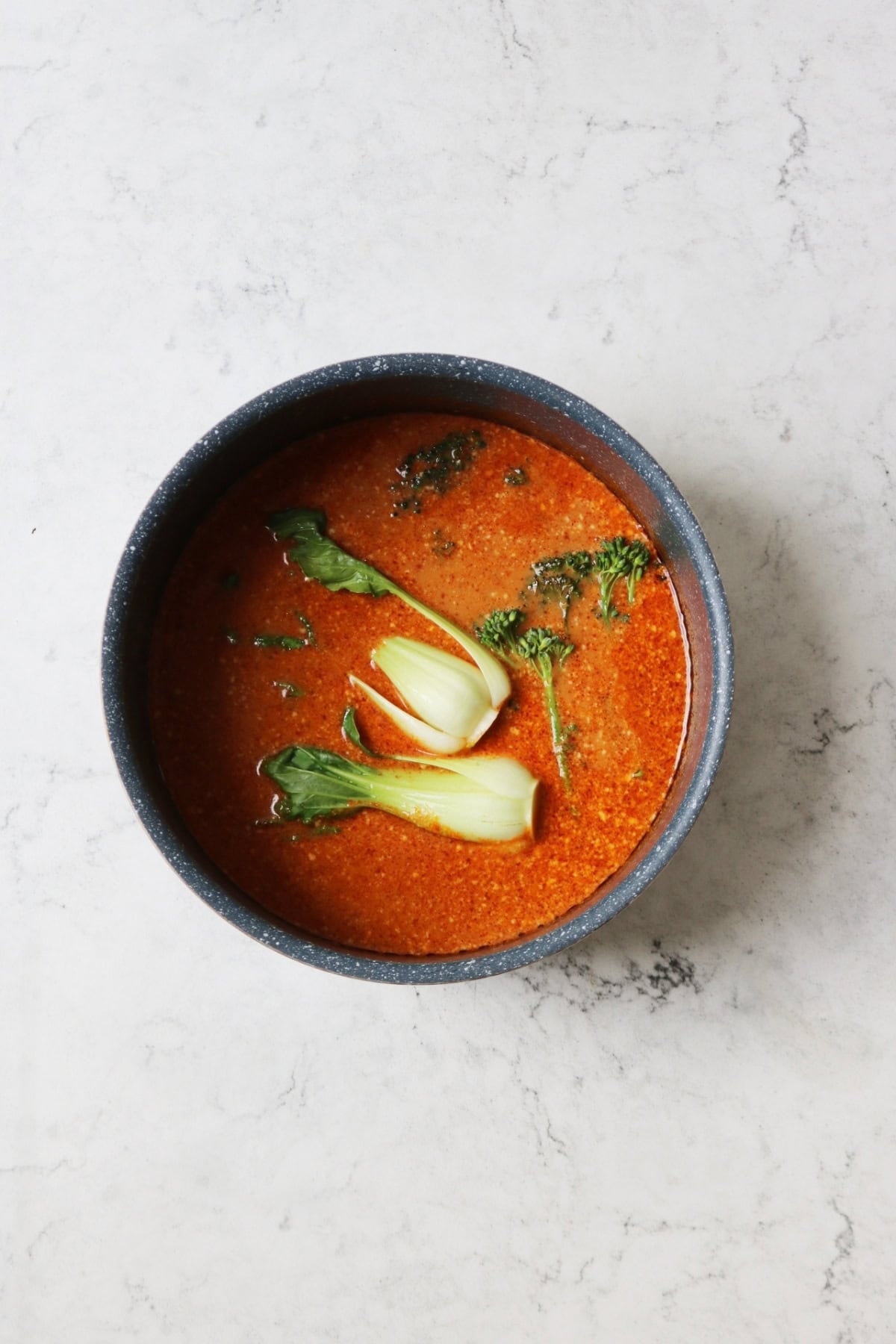 Simmering Vegan Thai Red Curry Noodle Soup with pak choi and Tenderstem broccoli