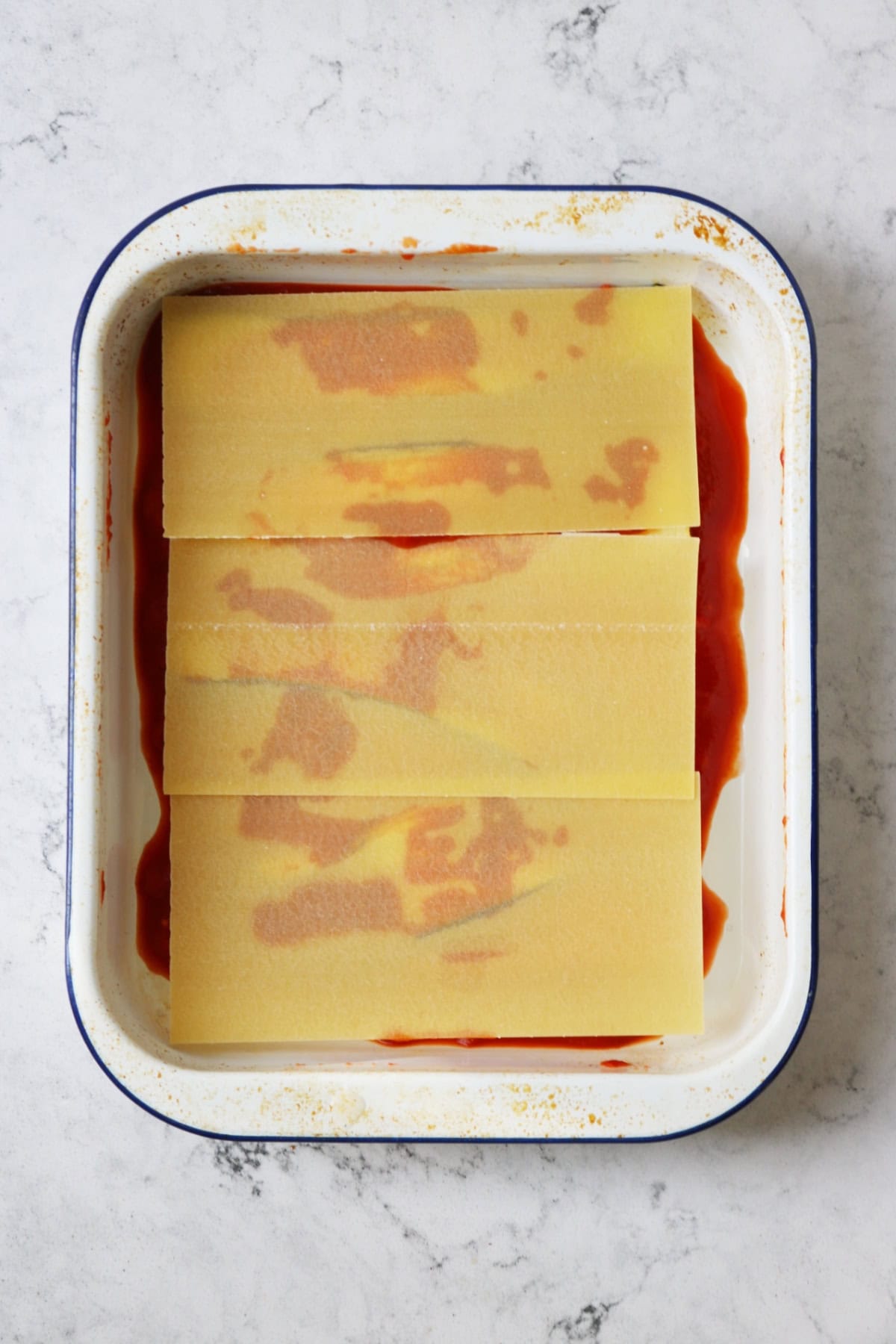 Layers of tomato sauce and roasted vegetables topped with lasagne sheets.