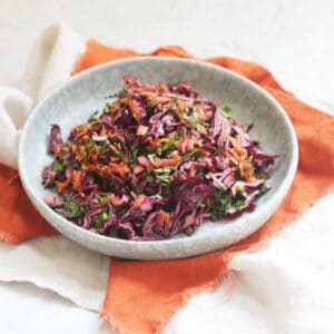 A plate of Turkish Red Cabbage Salad sat on top of a bright orange napkin
