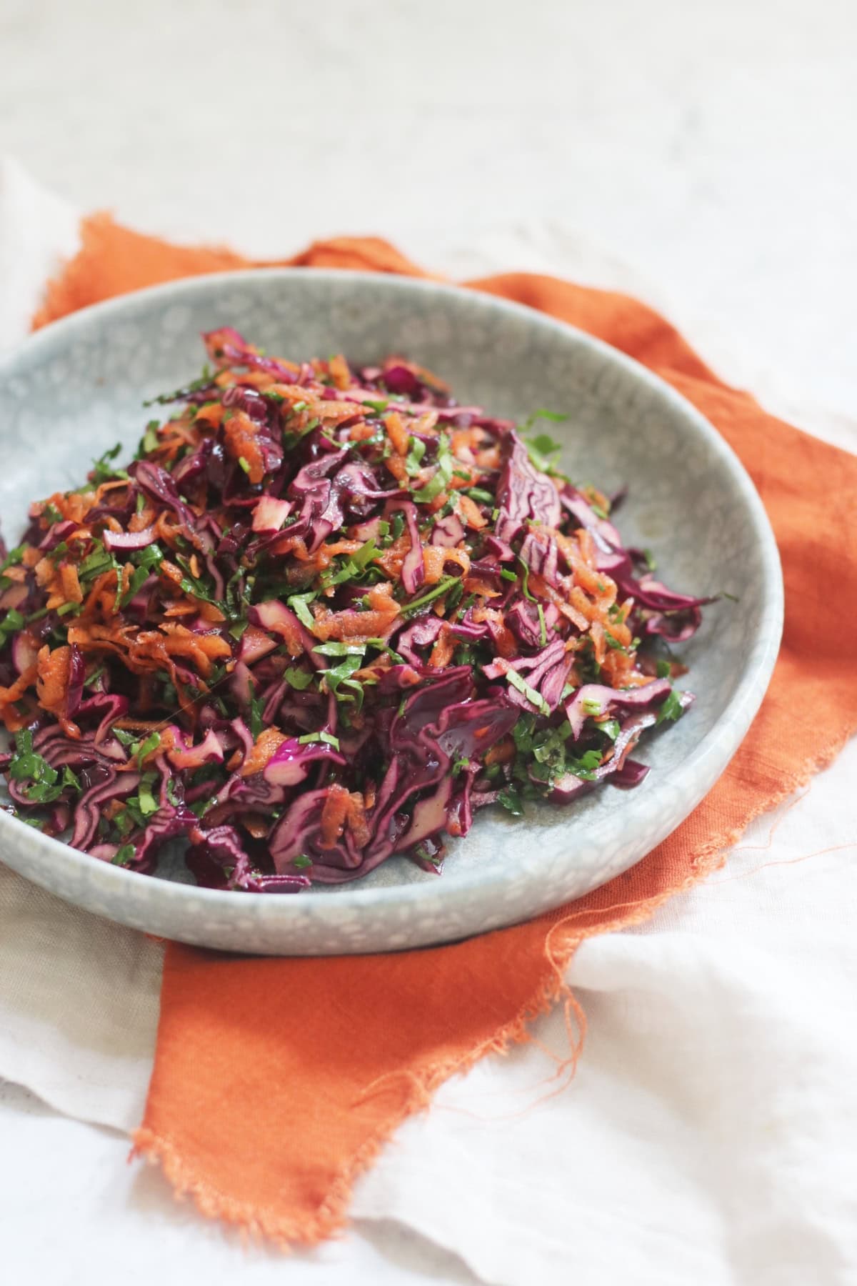 A plate of Turkish Red Cabbage Salad sat on top of a bright orange napkin