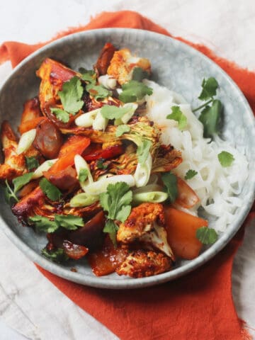 Vegan Gochujang Vegetable Traybake served with rice noodles and coriander
