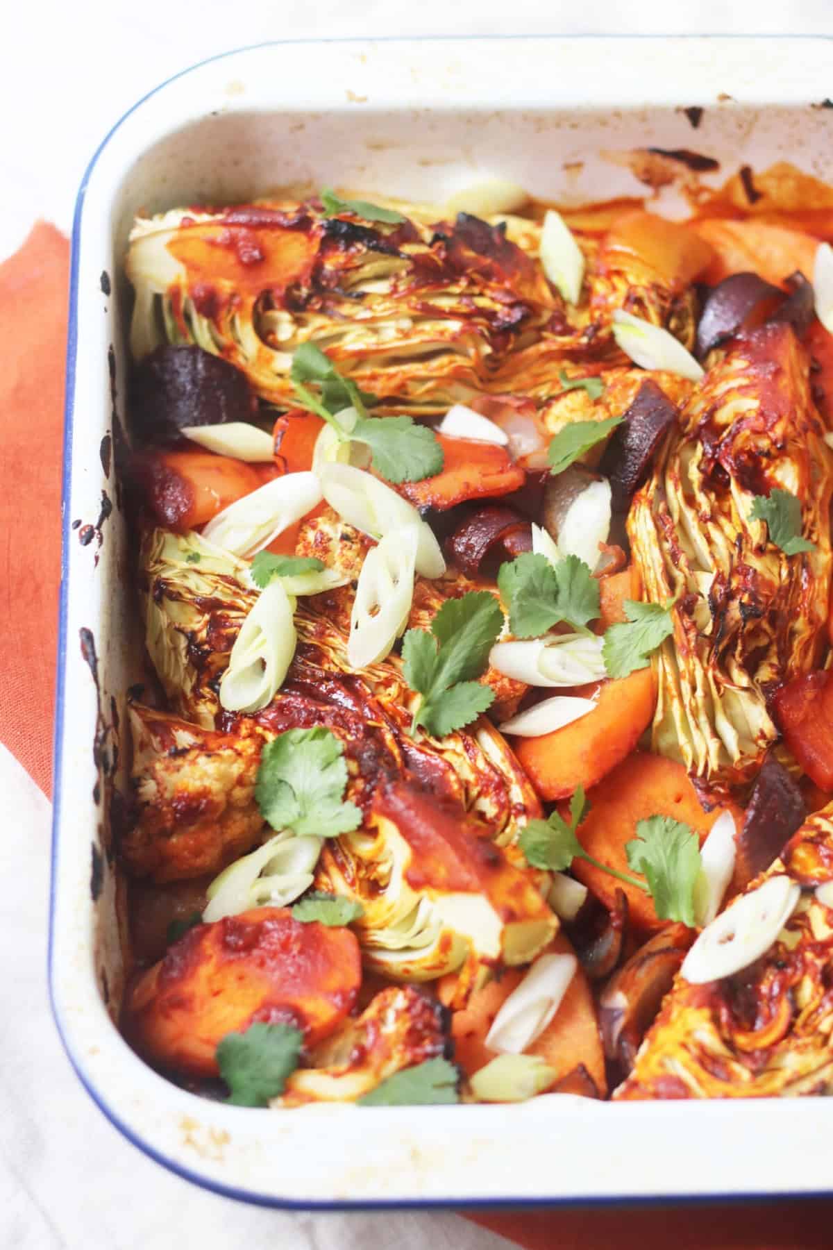 Vegan Gochujang Vegetable Traybake topped with spring onions and coriander