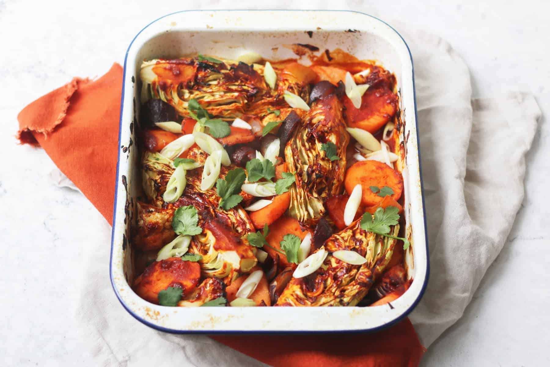 Vegan Gochujang Vegetable Traybake topped with spring onions and coriander