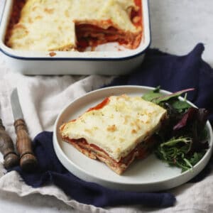 Vegan Roasted Vegetable Lasagne on a plate with green salad.
