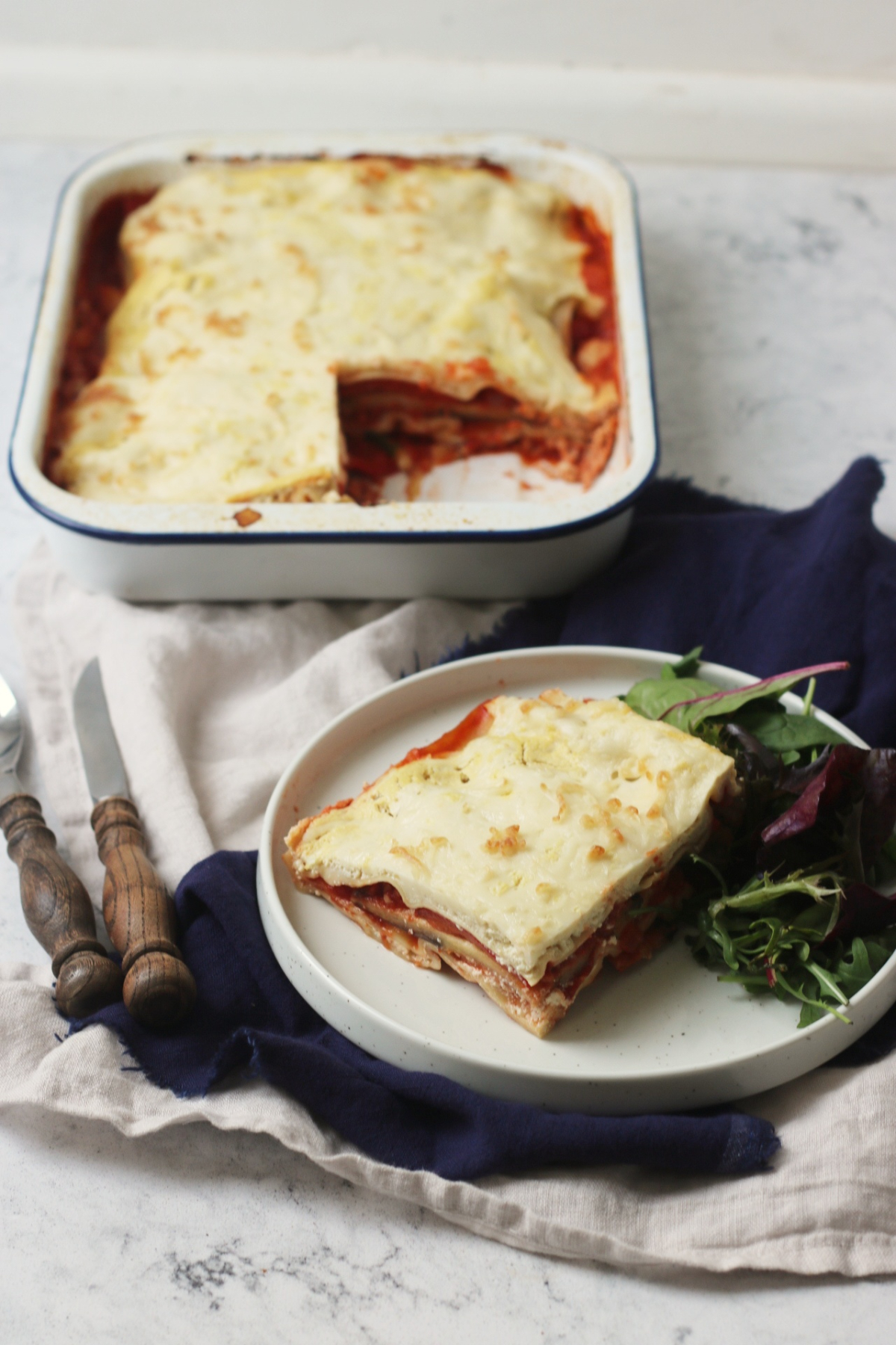 Vegan Roasted Vegetable Lasagne on a plate with green salad.