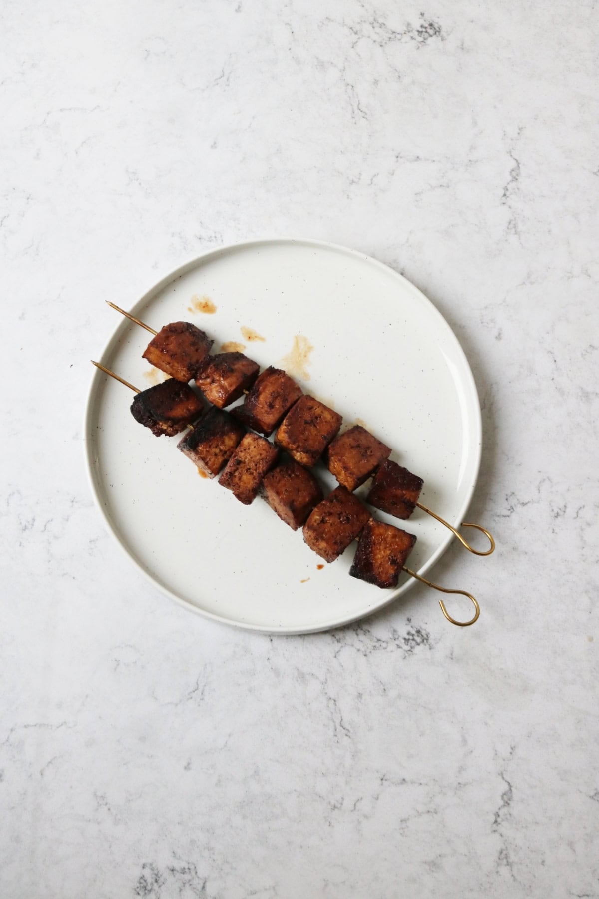 Grilled Pomegranate Molasses Tofu Kebabs served on a white plate