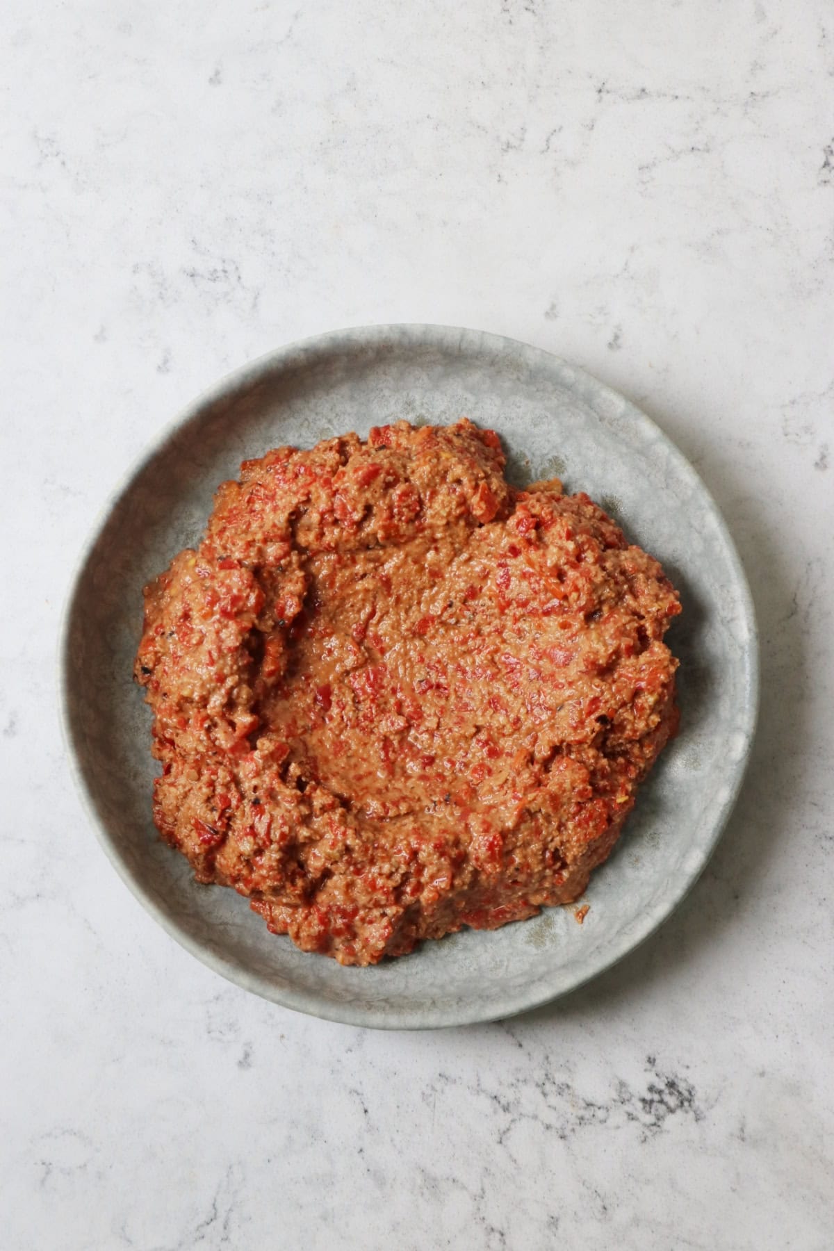Muhammara on a pale blue plate