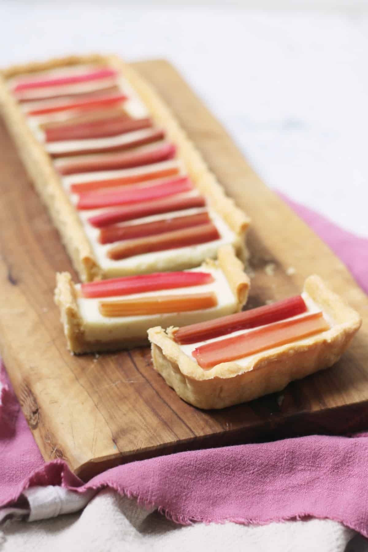 A close up of slices of a rectangular Vegan Rhubarb and Custard Tart