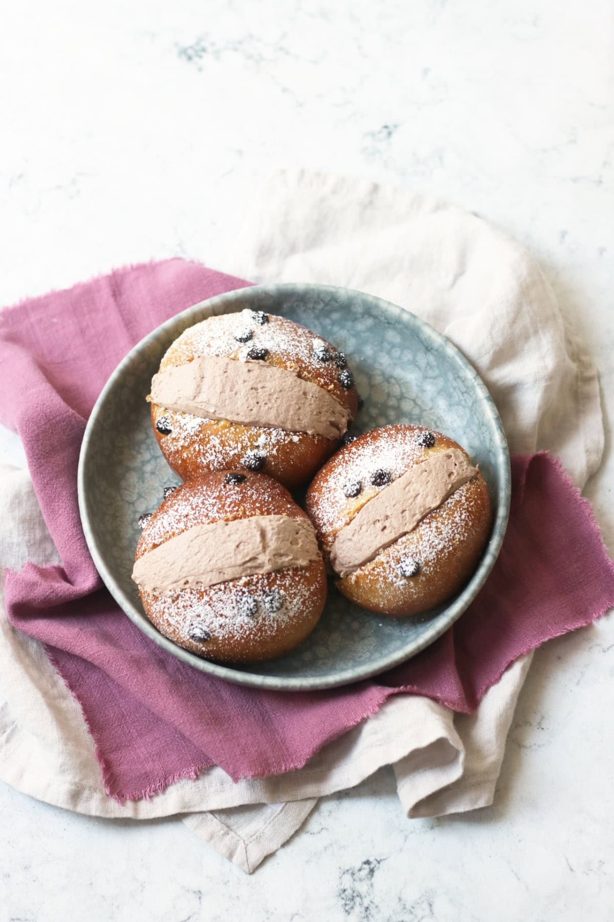Three Vegan Chocolate Maritozzi on a plate