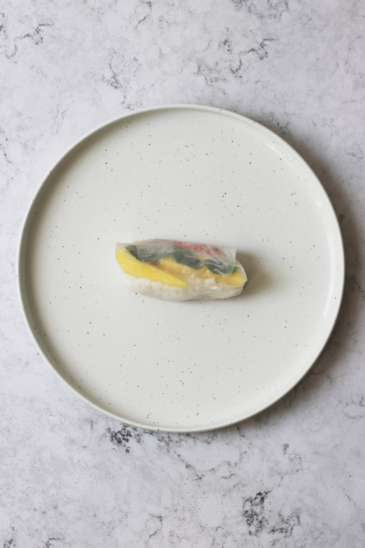 A single Sweet Summer Roll on a white plate