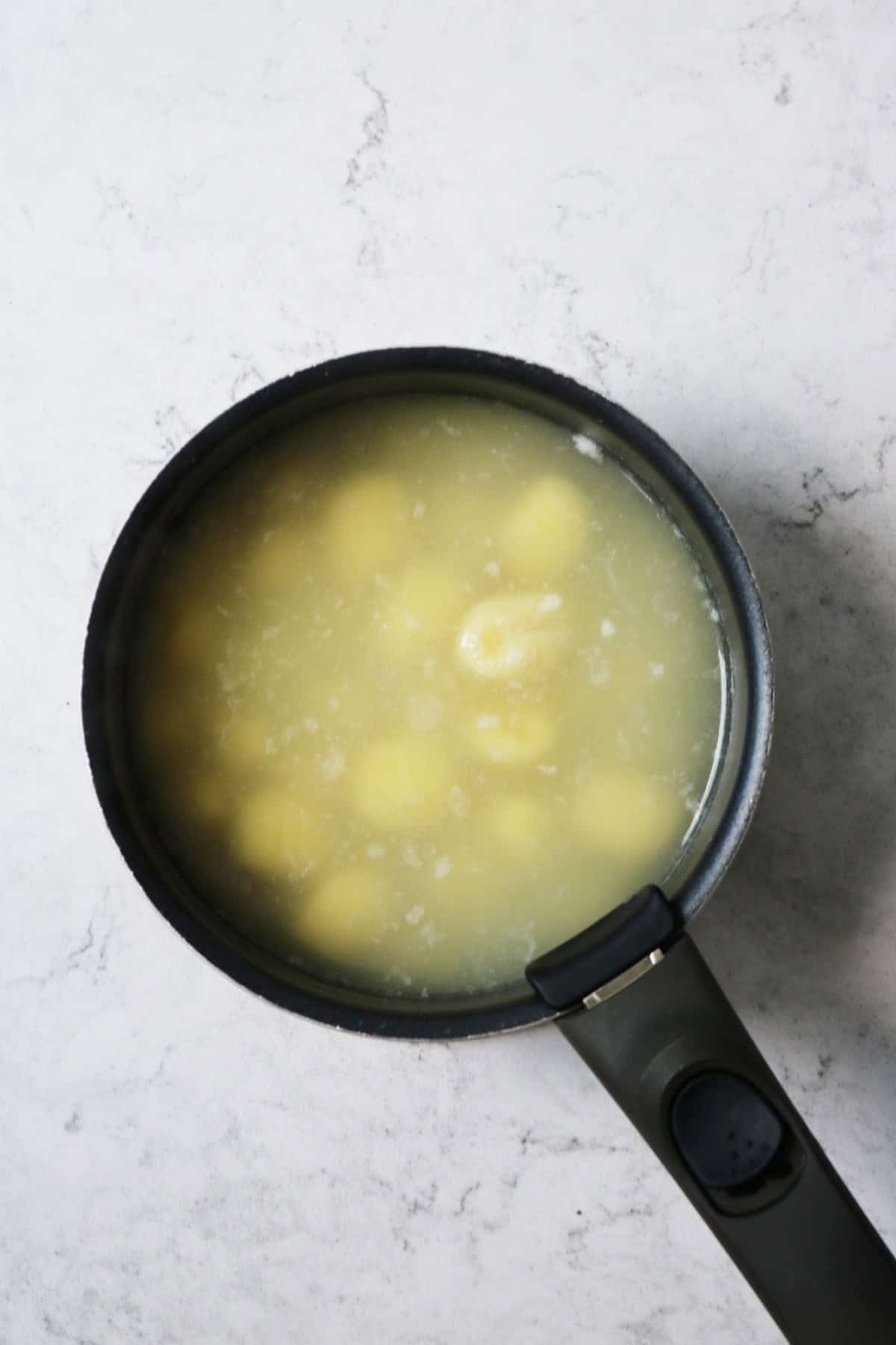 A saucepan of gnocchi cooking in lightly salted water