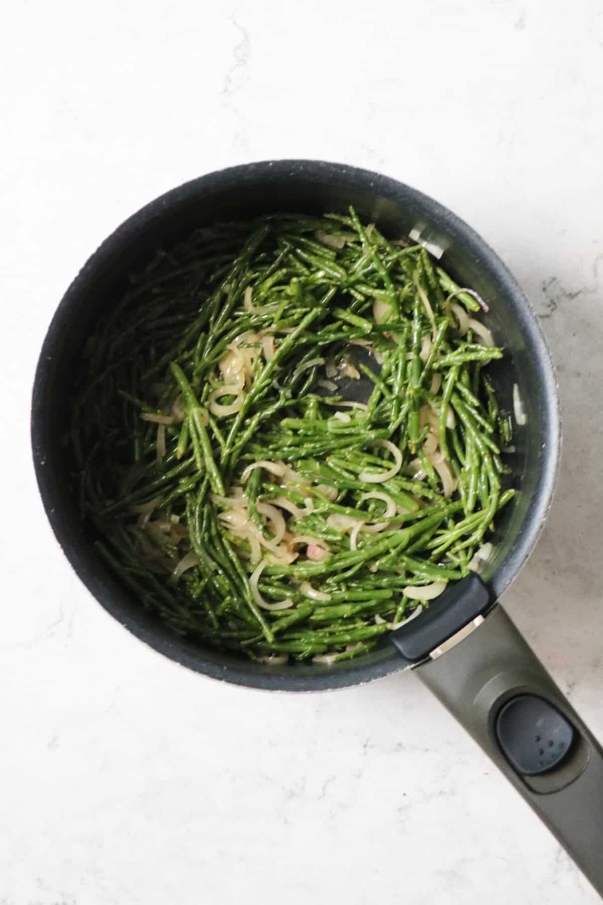 A saucepan of samphire, shallots and garlic