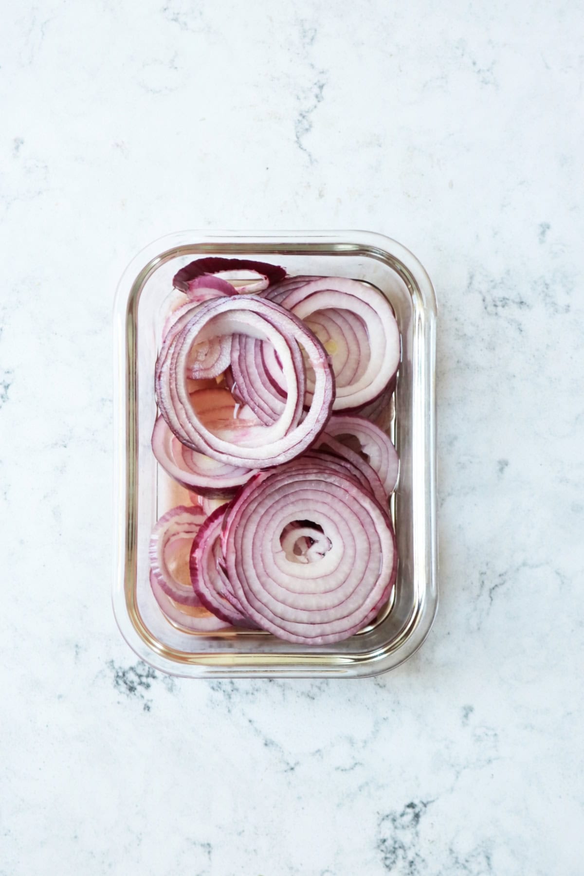 Rings of red onion pickling in white wine vinegar