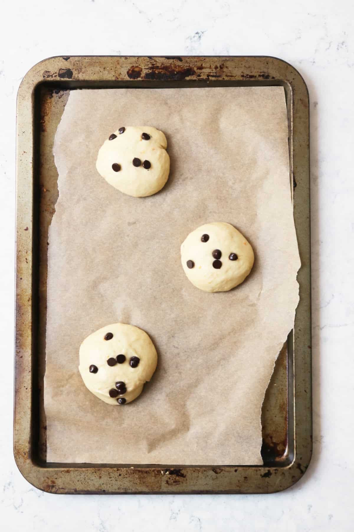 3 Vegan Chocolate Maritozzi buns proving on a baking tray