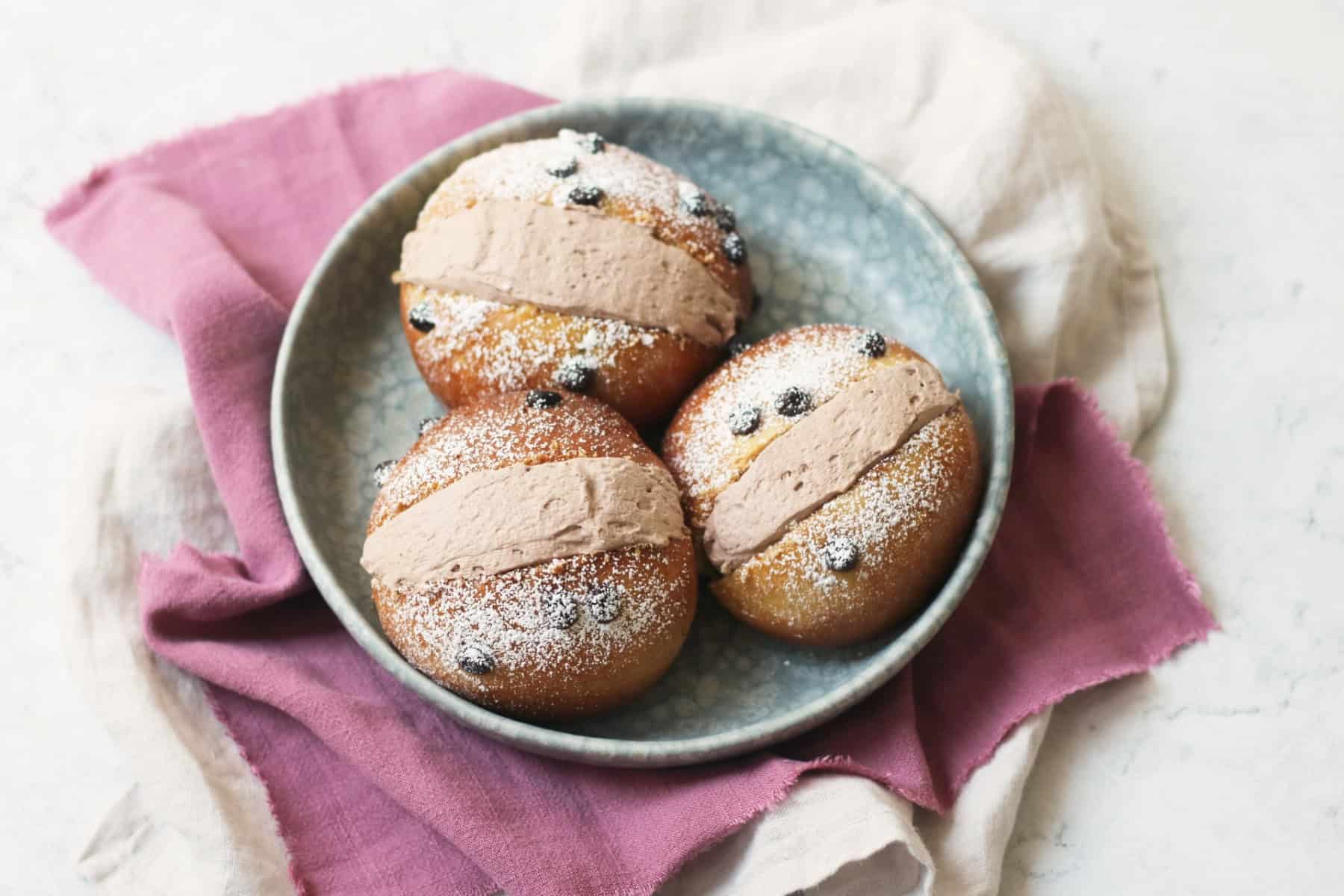 Three Vegan Chocolate Maritozzi on a plate
