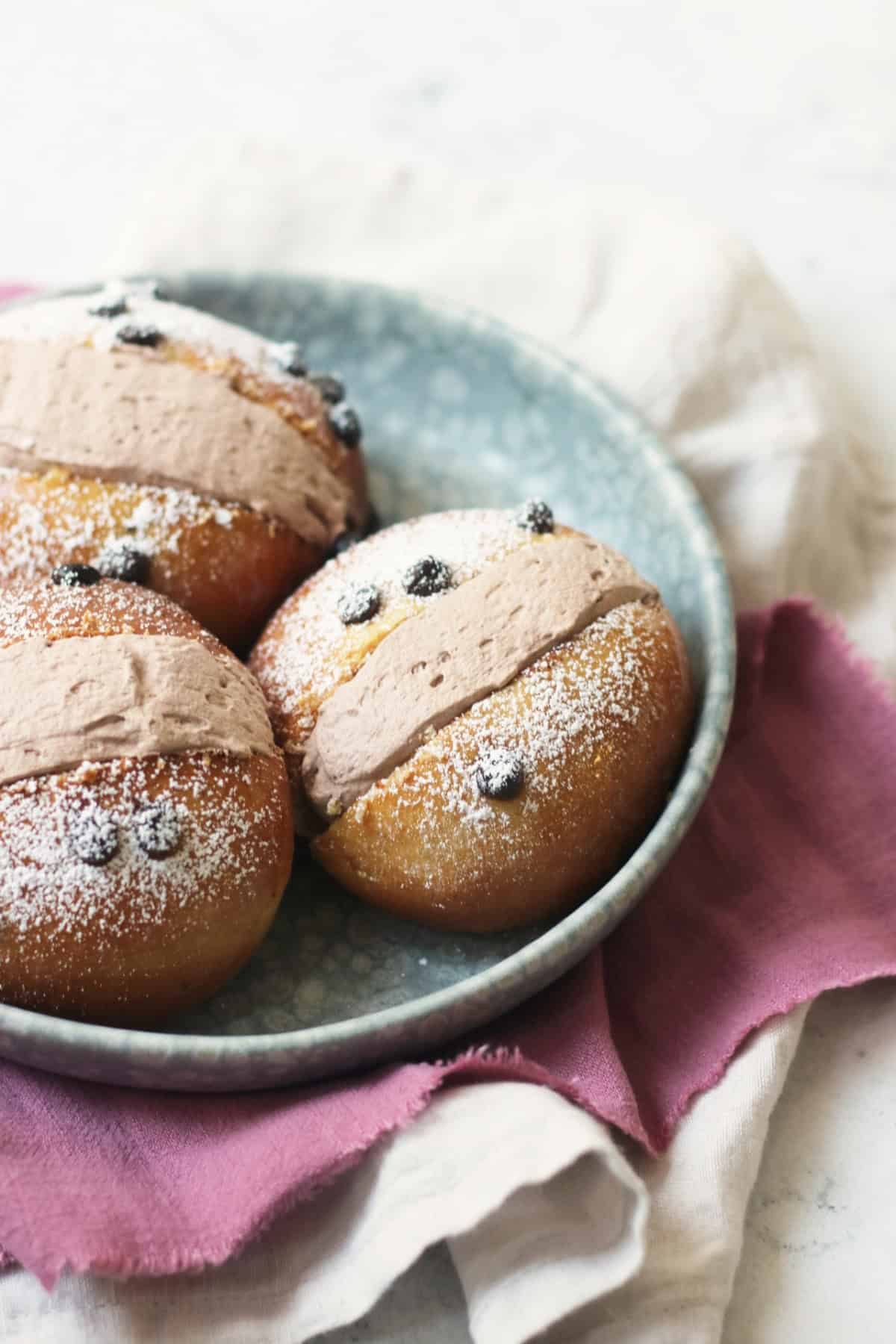 Three Vegan Chocolate Maritozzi on a plate