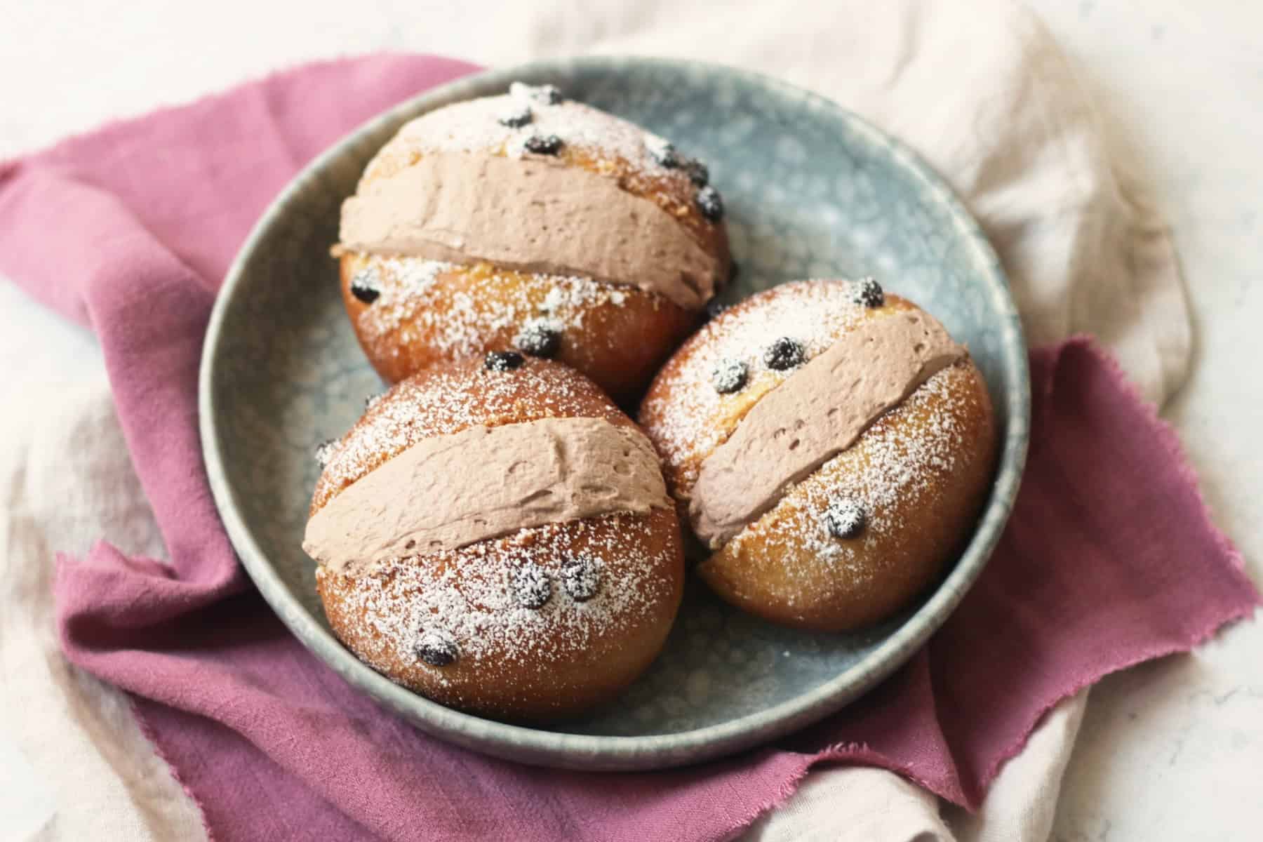 Three Vegan Chocolate Maritozzi on a plate